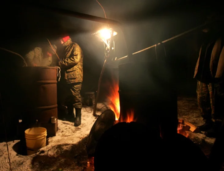 A villager produces moonshine vodka. Photo by Julia Darashkevich
